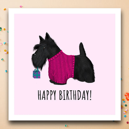 Birthday card with Scottish Highland Terrier in jumper holding a gift.