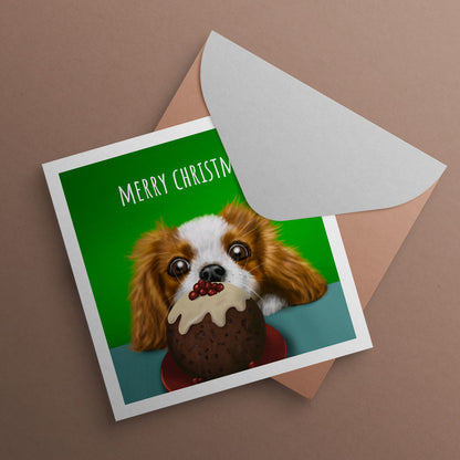 Cavalier King Charles Spaniel staring at Christmas pudding by Oundle Artist Kitty's Art